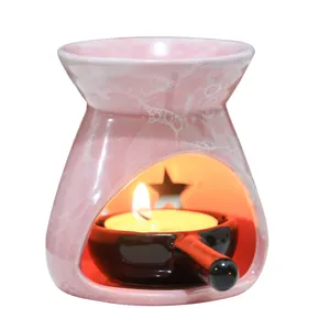 Pink ceramic essential oil burner with star cutout, aromatherapy candle wax warmer for home decor.