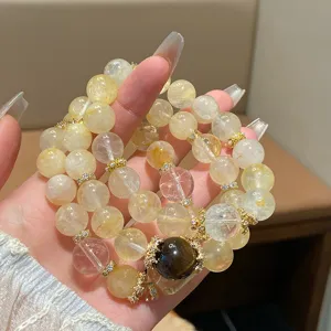 Close-up of natural yellow crystal beaded bracelet detail showcasing delicate gold spacer beads.