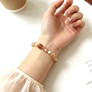 Detailed close-up view of a chic crystal beaded bracelet worn on a woman's wrist with elegance.