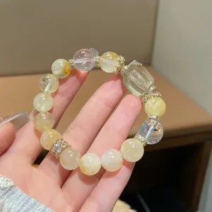 Close-up detail of the natural yellow quartz crystal bracelet featuring gold spacer beads.