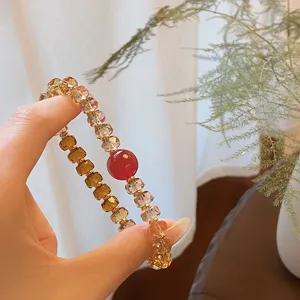 Close-up detail of the gradient crystal wheel bead bracelet with red accent stone, elegant style.