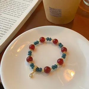 Chic Chinese style red agate beaded bracelet with gold spacers and cute pendant, elegant jewelry.