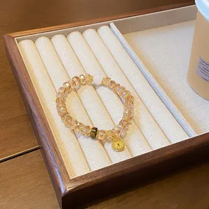 Close-up detail of the retro crystal bicone bead bracelet on a beige velvet tray display.