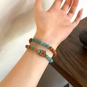 Exquisite double-layer beaded bracelet featuring natural stones, sandalwood, and floral charm.