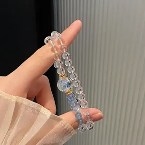 Double-layer crystal beaded bracelet with carved center bead and colorful clear design for women.