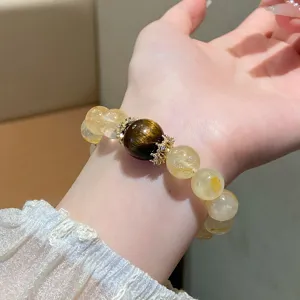 Close-up detail of natural yellow crystal gemstone bead bracelet featuring elegant gold spacers.