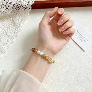 Exquisite mixed gemstone bracelet detail with pearls and sparkling beads for women.