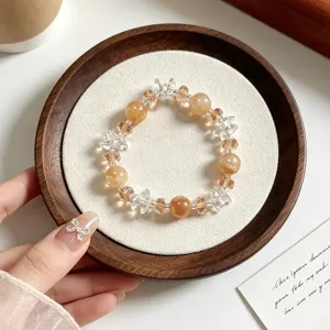 Detailed close-up of the elegant yellow crystal beaded bracelet with clear star crystal charms.