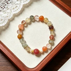 Exquisite multi-color rutilated quartz bracelet with pearls and golden spacers for elegant style.