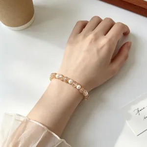 Elegant yellow crystal and pearl beaded elastic bracelet, niche retro chic design for women.