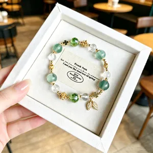 Light luxury green crystal bead bracelet with clover spacers and delicate leaf pendant.