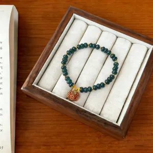 Neo-Chinese retro green chalcedony abacus bead bracelet featuring auspicious red pendant.