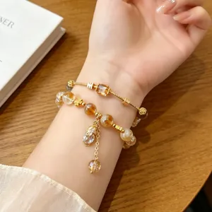 Details of the Chinese style crystal pixiu bracelet, featuring golden beads and charms.