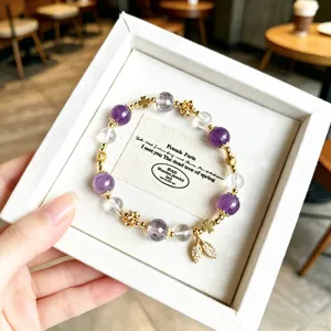Detailed close-up of a sweet crystal bead bracelet with a leaf pendant and gift box.