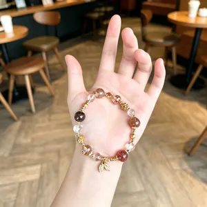 Exquisite natural crystal gemstone beaded bracelet with delicate golden leaf pendant for women.