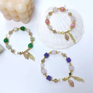 Charming multi-color beaded charm bracelets set with sparkling leaf pendants and delicate tassels.