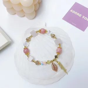 Charming pink crystal charm bracelet with dazzling leaf pendant and tassel for women.