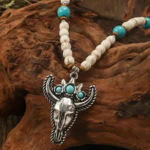 Close-up view of bohemian retro bull skull pendant necklace with turquoise and white beads.