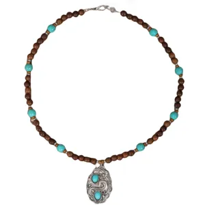 Vintage ethnic wooden bead necklace with turquoise stones and ornate silver pendant.
