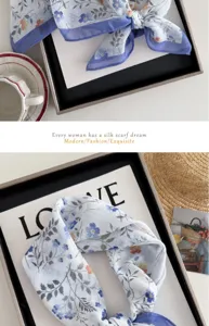 Close-up of blue floral cotton linen square scarf detail with elegant blue border styling.