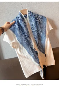 Vintage blue paisley silk scarf detail view, elegant triangle design for women neck wear.