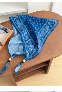 Blue paisley print triangular bandana scarf with beaded tassel details for women summer style.