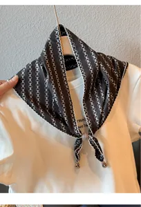 Detailed view of the black retro lace triangular scarf with chain print and pearl beads.