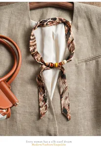 Elegant women's silk scarf with vintage wooden beads and chic animal print. Perfect fashion accessory.