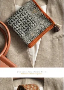Detailed shot of women's paisley print linen-feel square scarf with orange border and tassel.