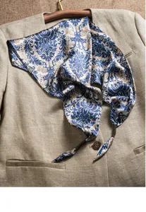 Exquisite blue paisley silk scarf detail, elegant pattern closeup for women chic style.