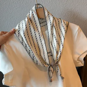 Retro chained print triangular scarf with white t-shirt, stylish summer fashion accessory.