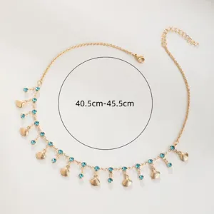 Gold seashell choker necklace with blue rhinestones, elegant fashion jewelry for women.