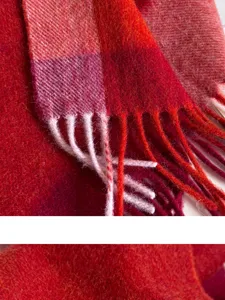 Red plaid wool scarf detail close up texture winter warm fringe soft cozy material