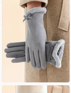 Detail view of women winter warm gloves featuring cute bow and cozy plush fur cuff design.