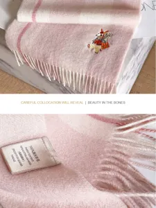 Pink plaid Australian wool scarf detail shot featuring cute embroidery and elegant soft fringes.