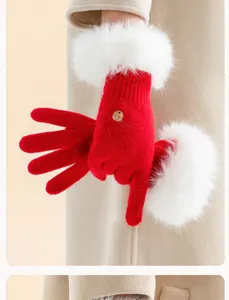 Red knit gloves with white fluffy faux rabbit fur cuffs, close-up warm winter handwear.