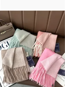 Detailed view of colorful wool winter scarves featuring cozy fringe design and soft texture.