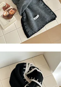 Detailed view of contrast color knitted winter scarf with soft wool texture for warm daily wear.