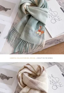 Stylish plaid wool scarf with cute embroidered rabbit detail, soft and warm winter accessory.