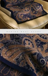 Dark blue paisley merino wool scarf detail shot, showing soft texture and vintage luxury style.
