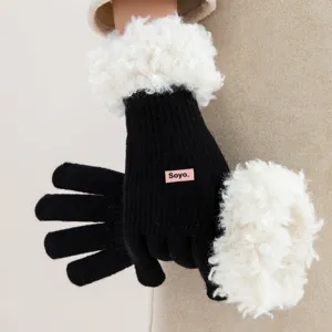 Winter black knitted gloves with white fluffy faux shearling fleece warm touch screen