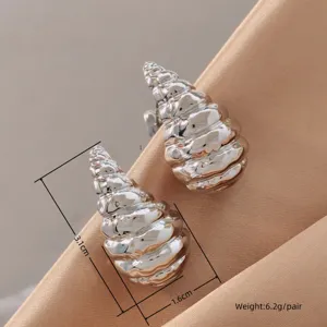Detail view of hammered metal water drop earrings, textured silver finish, elegant style.