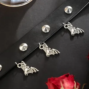 Gothic black leather choker necklace featuring metal spikes and cute hanging bat charms detail.