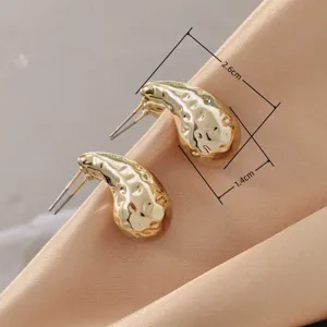 Gold hammered teardrop earrings for women, chic metal studs, elegant daily jewelry style.