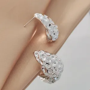 Waterdrop hammered texture detail shot of minimalist silver stud earrings for stylish women.