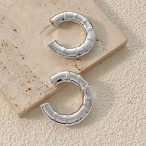 Chic silver bamboo textured hoop earrings for women, statement geometric jewelry style.