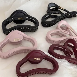 Matte hair claw detail view, elegant cloud and heart shapes in classic colors for daily styling.