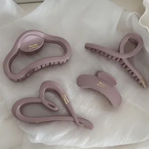 Matte finish gold letter hair claw clips set, elegant cloud and geometric hair accessories.