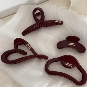 Matte burgundy hair claw clips set, elegant geometric design with gold lettering for women.