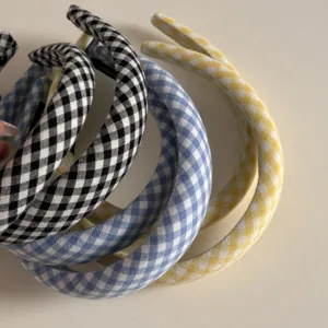 Close-up detail of classic gingham plaid sponge headbands featuring assorted colors for daily wear.